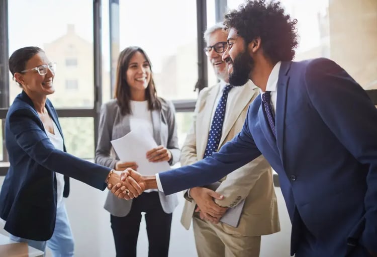 A contract manager and a supplier shaking hands after their meeting. A contract manager and a supplier shaking hands after their meeting.
