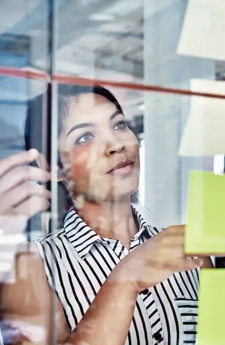 A woman using economic insights to create more accurate contracts. A woman using economic insights to create more accurate contracts.